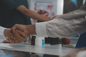 Doctor handshake and partnership in healthcare, medicine or trus